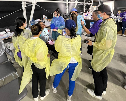 Dental Volunteers in Yellow Gowns at Clinic