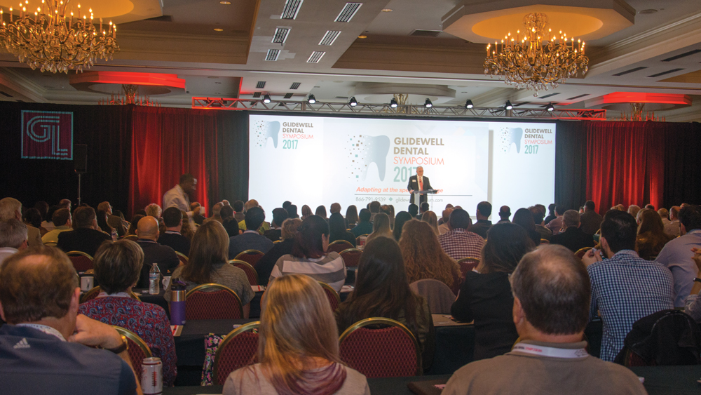 Behind the audience shot facing the speaker on stage