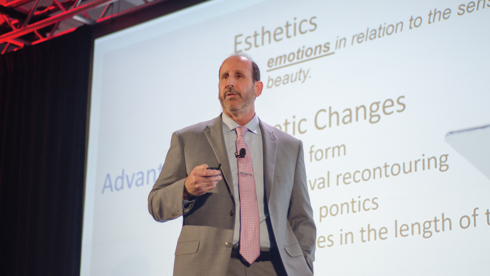 Dr. Steven Barrett presenting on stage