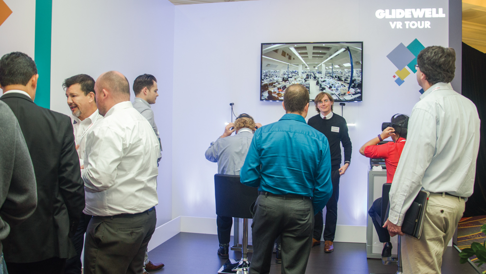 Attendees gathered around the Glidewell Dental virtual reality exhibit