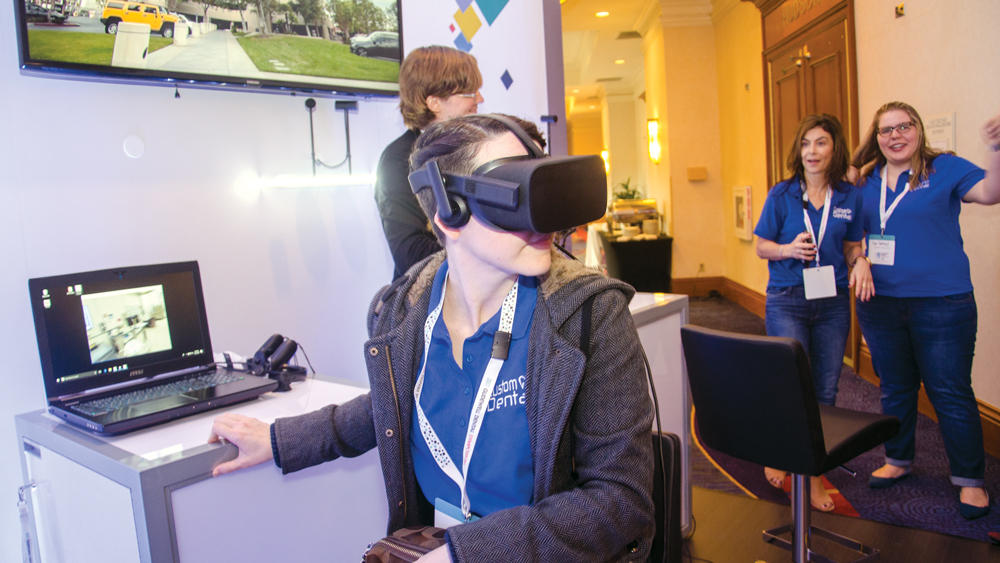 Woman trying out the Glidewell Dental VR tour of the Glidewell R&D and dental laboratory