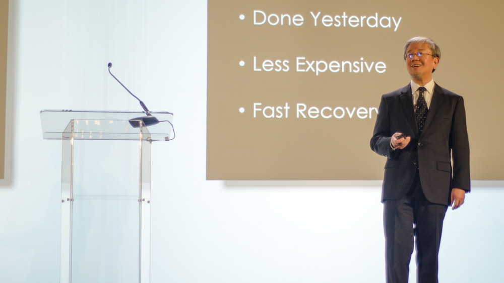 Dr. Raymond Choi, a leading expert in small-diameter implants, on stage at the first Glidewell Dental Symposium