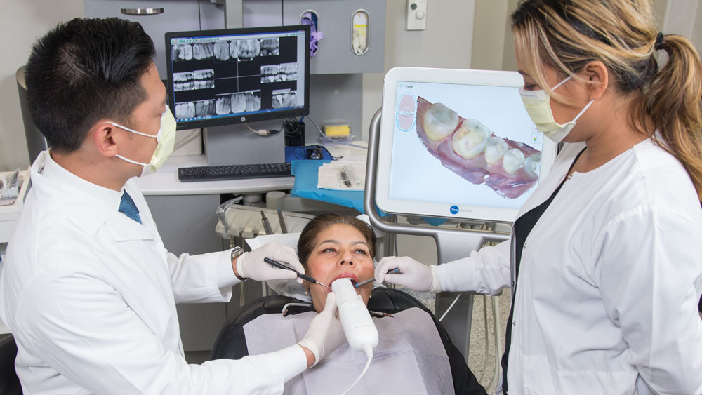 Dentists training on patient