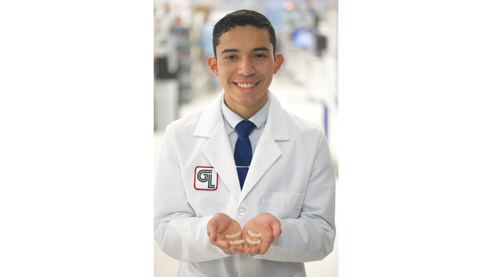 Dental lab worker showing CAD-enabled designs