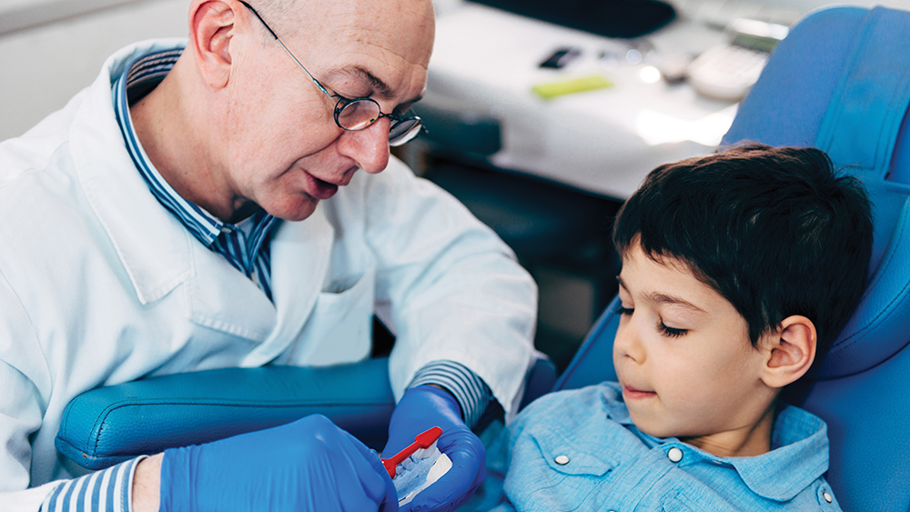 Pediatric dentist giving treatment to a child
