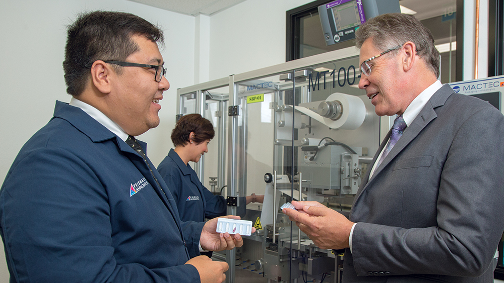Grant Bullist inspecting the inclusive prosthetic components with engineers