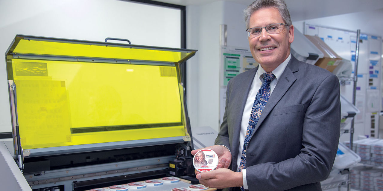 Grant Bullis, male with glasses, holding BruxZir Shaded 16 plus container