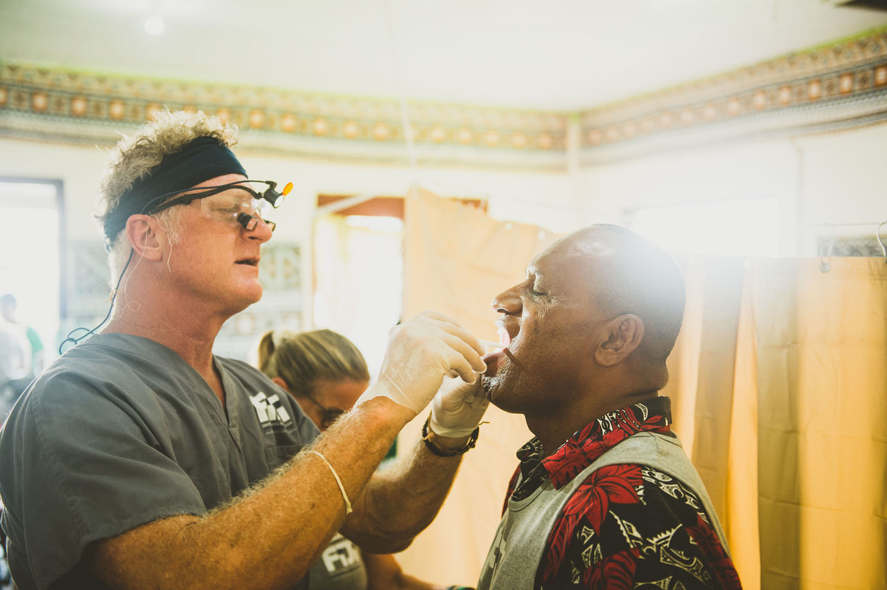 Dentist checking teeth of patient