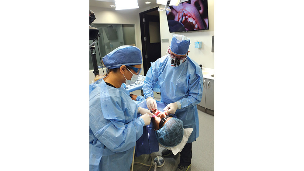 Dentists performing on patient