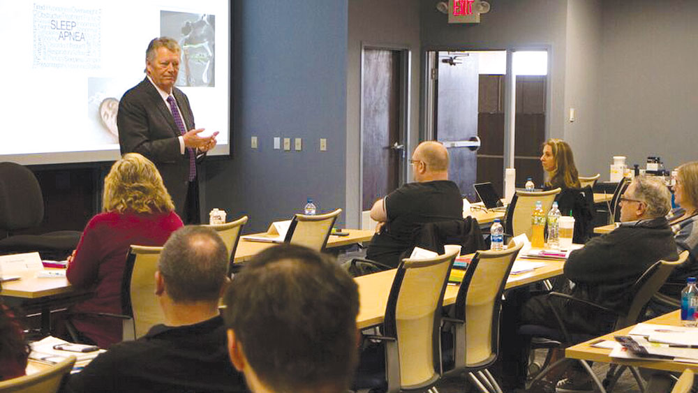 John Tucker teaching course to group of people