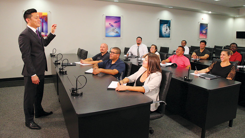 Dr. Justin Chi teaching among students