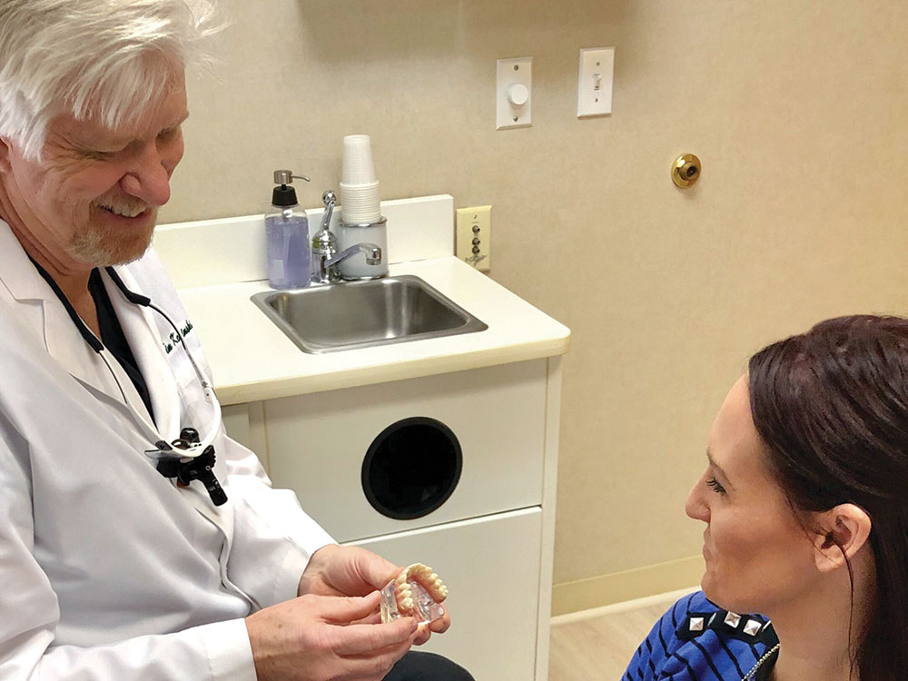 Dr. Timothy Kosinski showing patient full-arch implant