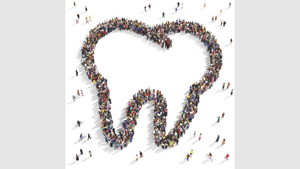 Aerial view of people making shape of tooth