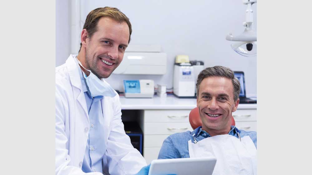 Dentist and patient smiling