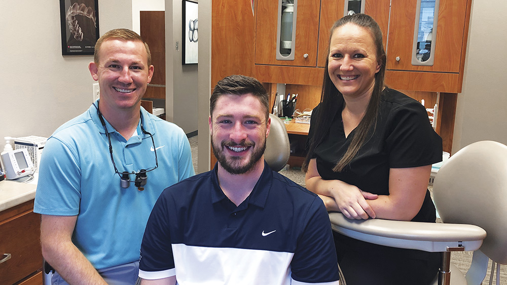 Dr. Buck with his patient and dental assistant