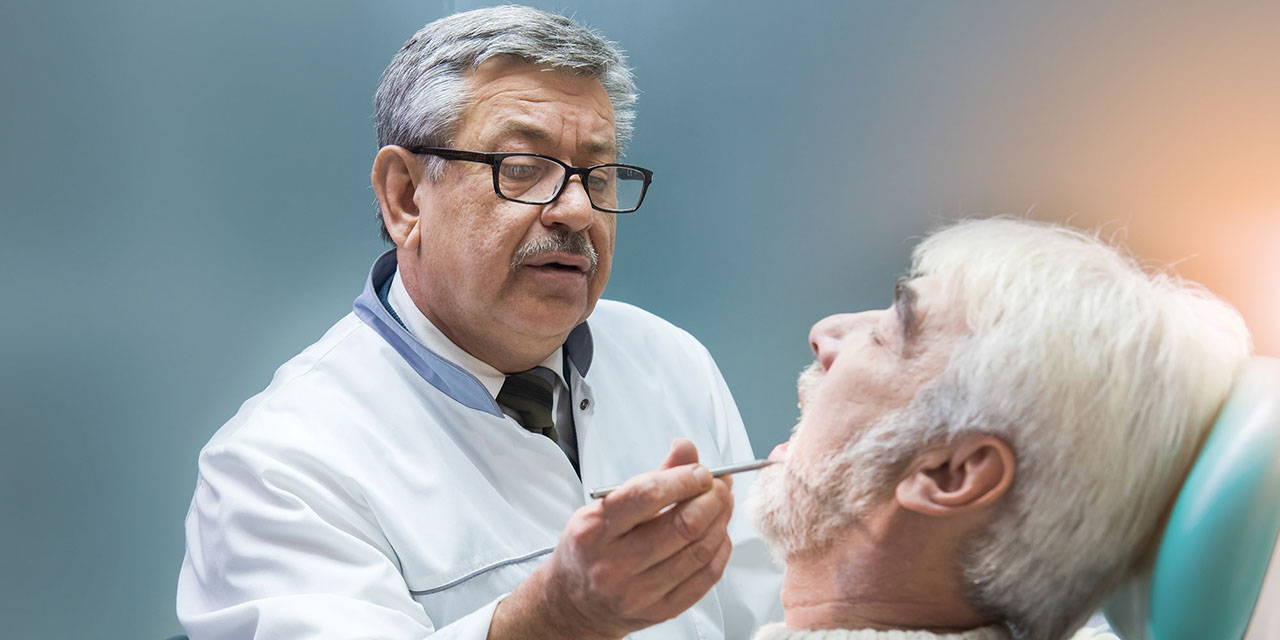 Dentist inspecting patient's teeth