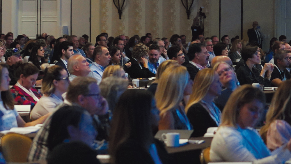 Attendees watching and listening attentively at the presentations