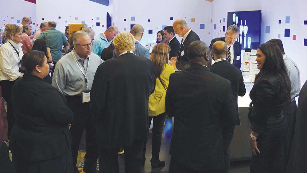 Attendees examining a high-traffic booth