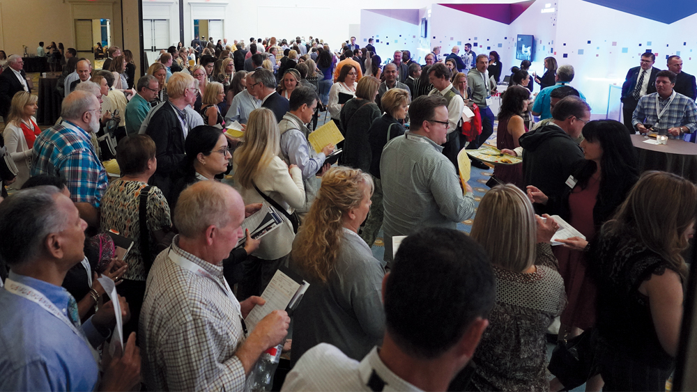 Attendees at an exhibit area that showcases dental innovations