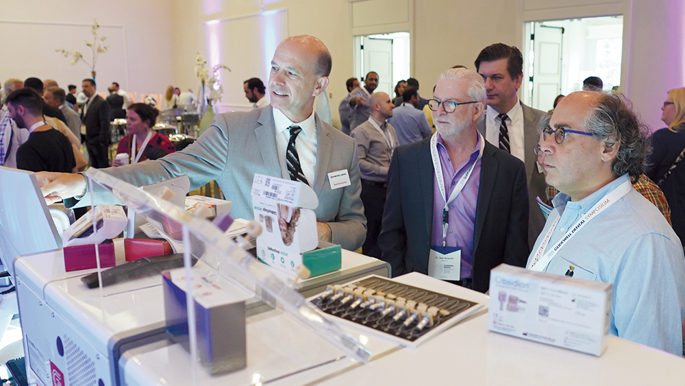 An instructor compares the features and benefits of restoration materials to attendees