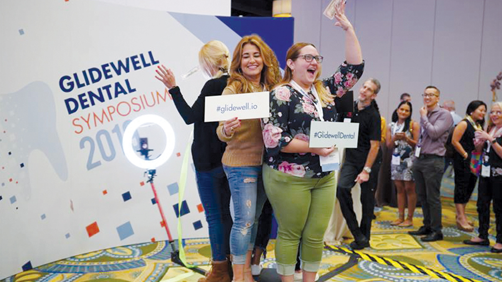 Attendees posing for a photo on the 360-degree photo booth