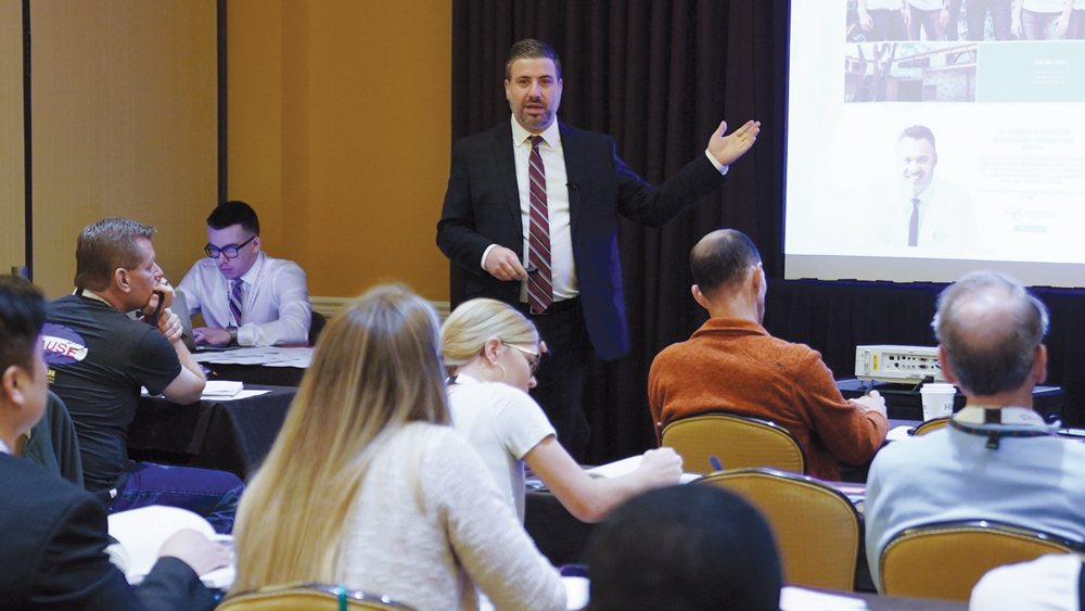 Mark Romano speaks during a lecture about effective marketing strategies