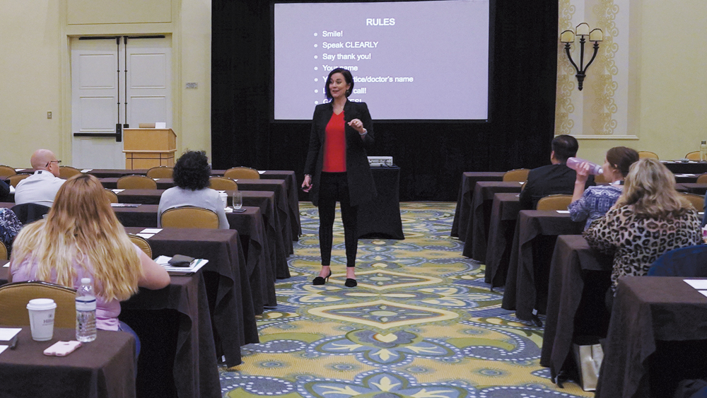 Carrie Webber speaks to an audience of attendees during a course