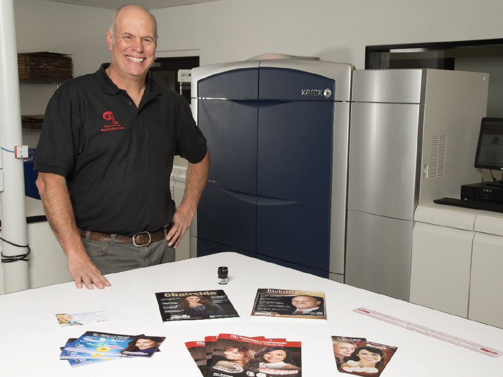 A Glidewell employee showcasing printed materials