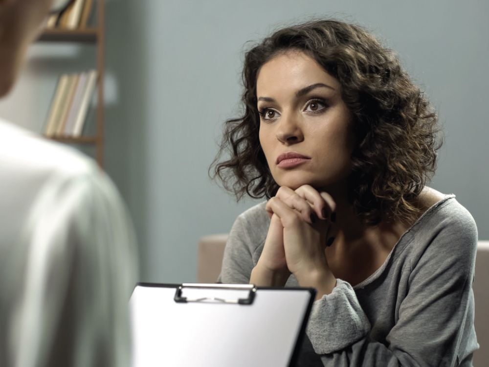 Female patient listening to her check-up intently