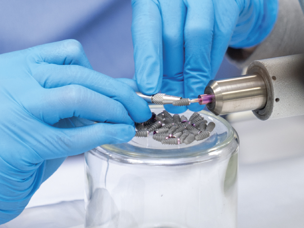 Dental tech working on implant parts