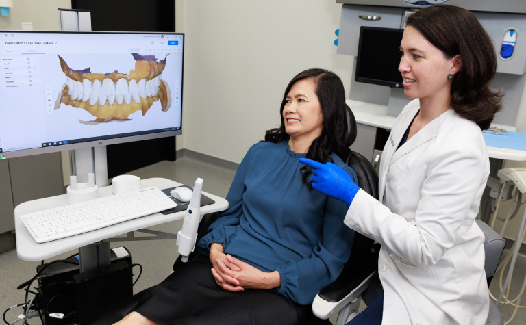 Dr. Manalilli with patient looking at scan